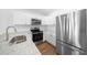 Modern kitchen featuring stainless steel appliances, sleek countertops, and ample storage space at 3554 Arrowhead Ave, Spring Hill, FL 34606