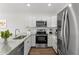 Well-appointed kitchen with stainless steel appliances, granite countertops, and ample cabinet space at 3554 Arrowhead Ave, Spring Hill, FL 34606
