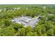 Aerial view showcases a parking area for boats and RVs surrounded by trees in a residential community at 3900 Autumn Amber Dr, Spring Hill, FL 34609