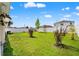 Lush green backyard, enclosed with a white fence and some landscaping at 3900 Autumn Amber Dr, Spring Hill, FL 34609