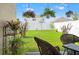 Beautiful backyard with lush green grass, mature landscaping, and a privacy fence at 3900 Autumn Amber Dr, Spring Hill, FL 34609