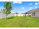 Large backyard with healthy green lawn space and perimeter fencing, offering privacy at 3900 Autumn Amber Dr, Spring Hill, FL 34609