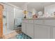 Bright bathroom featuring a glass door shower, white vanity, and blue accents at 3900 Autumn Amber Dr, Spring Hill, FL 34609