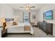 Cozy bedroom with neutral tones, a ceiling fan, and a mounted television at 3900 Autumn Amber Dr, Spring Hill, FL 34609