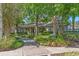 Inviting clubhouse featuring lush landscaping, a covered entrance, and a welcoming walkway perfect for community gatherings at 3900 Autumn Amber Dr, Spring Hill, FL 34609