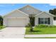 Charming one-story home with a well-maintained lawn and inviting two-car garage, providing curb appeal at 3900 Autumn Amber Dr, Spring Hill, FL 34609