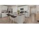 Modern kitchen featuring white cabinets, a granite island with seating, and stainless steel appliances perfect for cooking at 3900 Autumn Amber Dr, Spring Hill, FL 34609