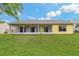 View of screened in lanai and exterior of home from backyard at 4125 Mc Clung Dr, New Port Richey, FL 34653