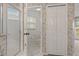 En-suite bathroom with a glass shower, separate toilet room, and decorative wallpaper at 4125 Mc Clung Dr, New Port Richey, FL 34653
