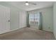 Comfortable bedroom with carpet, ceiling fan, closet, and a window with blinds and curtains at 4125 Mc Clung Dr, New Port Richey, FL 34653