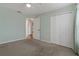 Bedroom featuring a ceiling fan, carpeted floor, and closet for ample storage at 4125 Mc Clung Dr, New Port Richey, FL 34653