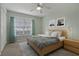 Cozy bedroom with a ceiling fan, wooden furniture, soft lighting and a neutral color scheme at 4125 Mc Clung Dr, New Port Richey, FL 34653