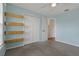 Light blue bedroom with built-in shelves, closet, and neutral carpet at 4125 Mc Clung Dr, New Port Richey, FL 34653