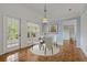 Charming dining area featuring a decorative chandelier, light blue walls, and natural light at 4125 Mc Clung Dr, New Port Richey, FL 34653