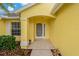 Inviting front entryway with a decorative door, columns, and manicured landscaping at 4125 Mc Clung Dr, New Port Richey, FL 34653