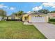 Charming yellow single-story home with a well-manicured lawn and a two-car garage at 4125 Mc Clung Dr, New Port Richey, FL 34653