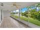 Screened lanai overlooking a serene lake with a fountain and lush greenery at 4125 Mc Clung Dr, New Port Richey, FL 34653