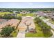 Aerial view of a home featuring a well-maintained lawn, landscaping, and a spacious driveway at 4266 High Ridge Ave, Spring Hill, FL 34609