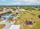 Aerial view of a house with a large yard and a community playground surrounded by lush landscaping at 4266 High Ridge Ave, Spring Hill, FL 34609