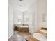Bright bathroom featuring a soaking tub, double vanity, and natural light from two windows at 4266 High Ridge Ave, Spring Hill, FL 34609