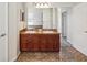 Bathroom with double vanity, wood cabinets, large mirror, and tile flooring at 4266 High Ridge Ave, Spring Hill, FL 34609