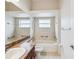 Bright bathroom featuring a shower over tub and large mirror at 4266 High Ridge Ave, Spring Hill, FL 34609