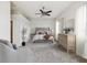 Neutral bedroom showcases a plush bed, soft carpet and an ensuite bathroom at 4266 High Ridge Ave, Spring Hill, FL 34609