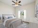 Relaxing bedroom with soft carpet, a ceiling fan, and a street view window at 4266 High Ridge Ave, Spring Hill, FL 34609