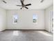 Bright bedroom featuring neutral paint and carpeting, a ceiling fan, and views of the neighborhood at 4266 High Ridge Ave, Spring Hill, FL 34609