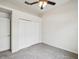 Bedroom featuring neutral carpet, ceiling fan and double door closet at 4266 High Ridge Ave, Spring Hill, FL 34609