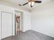This bedroom has a ceiling fan and access to a closet and en-suite bathroom at 4266 High Ridge Ave, Spring Hill, FL 34609