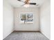 This bedroom features a ceiling fan and a large window with a neighborhood view at 4266 High Ridge Ave, Spring Hill, FL 34609