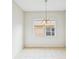 Light filled dining room with neutral tile flooring and bright chandelier at 4266 High Ridge Ave, Spring Hill, FL 34609