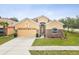 Charming home with a two-car garage, stone accents, and a beautifully landscaped front yard at 4266 High Ridge Ave, Spring Hill, FL 34609