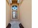 Covered front entry featuring a glass paneled front door and updated lighting at 4266 High Ridge Ave, Spring Hill, FL 34609
