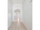 Hallway featuring tile floors, white walls and arched openings at 4266 High Ridge Ave, Spring Hill, FL 34609