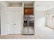 A stainless steel refrigerator and cabinet with adjacent double-door pantry enhance this kitchen at 4266 High Ridge Ave, Spring Hill, FL 34609