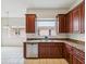 Kitchen featuring wood cabinets, stainless dishwasher and double sink at 4266 High Ridge Ave, Spring Hill, FL 34609