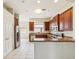 Eat-in kitchen featuring wood cabinets and stainless steel appliances at 4266 High Ridge Ave, Spring Hill, FL 34609