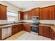 Well-lit kitchen with wood cabinets, stainless steel appliances and granite counters at 4266 High Ridge Ave, Spring Hill, FL 34609