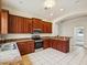 Kitchen featuring wood cabinets, stainless appliances, and tile floors at 4266 High Ridge Ave, Spring Hill, FL 34609