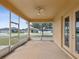 Enjoy outdoor living on this screened lanai with ceiling fan and views of the neighborhood at 4266 High Ridge Ave, Spring Hill, FL 34609