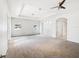 This expansive living room features recessed lighting, neutral paint and carpeting, and arched entryway at 4266 High Ridge Ave, Spring Hill, FL 34609