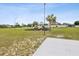 Community playground featuring multiple slides and climbing structures surrounded by green space and palm trees at 4266 High Ridge Ave, Spring Hill, FL 34609