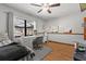 Bedroom featuring a ceiling fan, a desk area, hardwood floors, and natural light at 4289 Castle Ave, Spring Hill, FL 34609