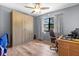 Bedroom featuring a desk, wood floors, built-in wardrobe, and bright lighting at 4289 Castle Ave, Spring Hill, FL 34609