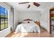 Bedroom with hardwood floors, a large window, and a ceiling fan at 4289 Castle Ave, Spring Hill, FL 34609