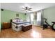 This bedroom features wood floors, a ceiling fan, and plenty of natural light at 4289 Castle Ave, Spring Hill, FL 34609