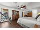 Well-decorated bedroom featuring a bed, wood furnishings, ceiling fan and an inversion table at 4289 Castle Ave, Spring Hill, FL 34609