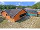 Back of house featuring enclosed pool, grill, and well-maintained yard at 4289 Castle Ave, Spring Hill, FL 34609